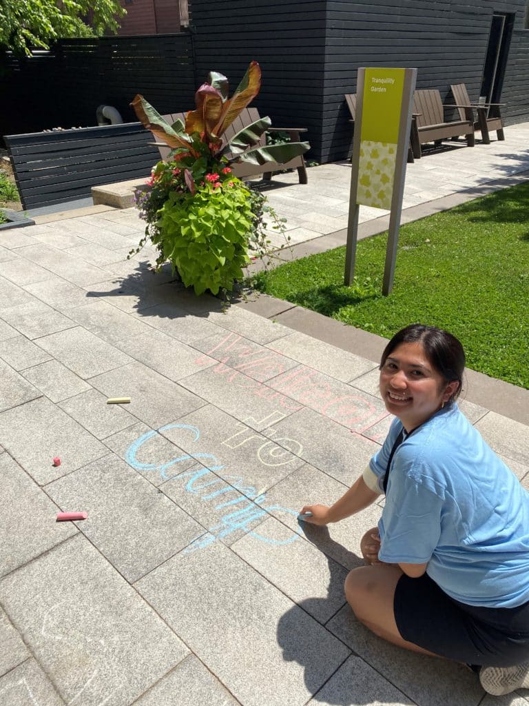 Alyssa draws with chalk